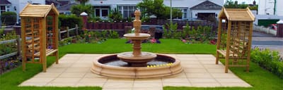 A garden area with a fountain and benches