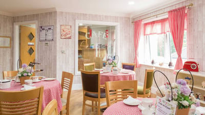 Bright dining room with café tables and floral decor