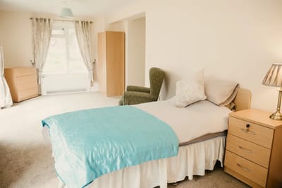 Well-furnished private resident room with bed and chair