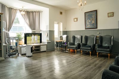 A cozy common area with seating and a TV