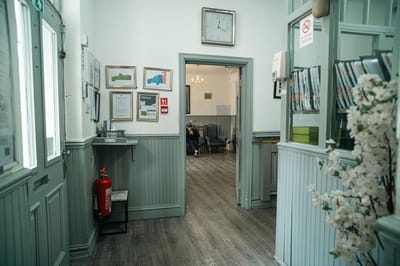 Interior hallway of a care home with a resident