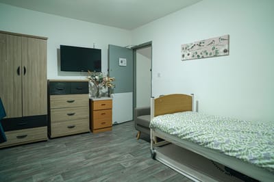 Interior of a resident room with bed and furniture