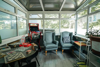 Common area with seating and games for residents