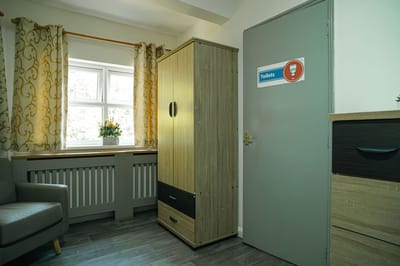 A cozy private resident room with a window