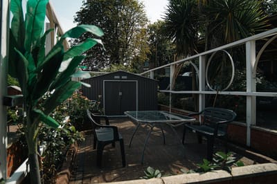 Outdoor patio area with seating and greenery