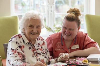 Resident and staff enjoying an activity together