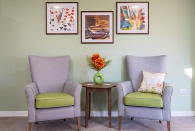 Two armchairs in a cozy common area with decorations