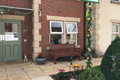 Exterior view of a senior living facility with flowers