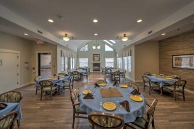 Dining room setup with blue tablecloths and yellow plates