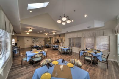 Bright dining area with tables set for residents