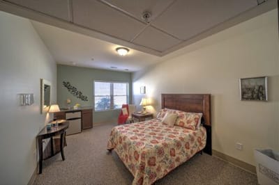 Cozy resident room with a bed and desk