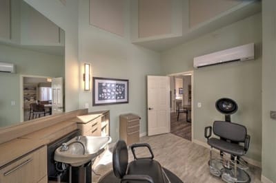 A salon area with styling chairs and a wash basin