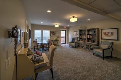A cozy common area with bookshelves and seating
