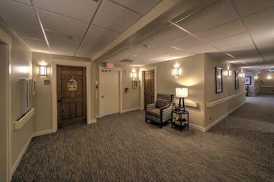 Interior hallway with doors and seating area