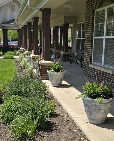 Garden walkway with flower pots beside the building