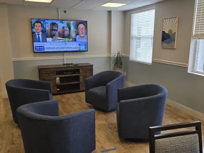 Common area with chairs and a TV