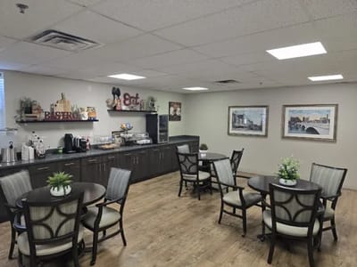 Interior view of a dining area with tables and kitchen amenities