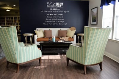 Comfortable seating area in a lobby with mission statement.
