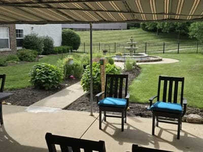 View of a landscaped outdoor area with chairs and a fountain