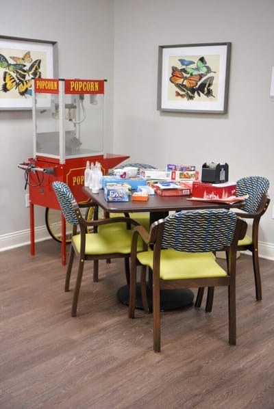 Table with games and a popcorn machine in an activity room