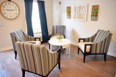 Common area with chairs and decor in a light-filled room
