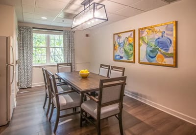 Bright dining room with a table and artwork