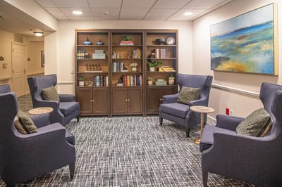 Cozy common area with comfortable seating and bookshelves