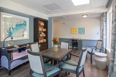 Bright activity room with residents and decor