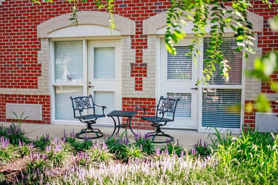 Outdoor seating area with plants in a senior living community