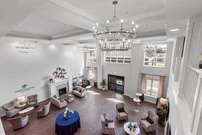 Bright common area with seating and chandeliers