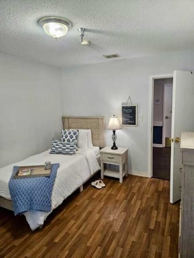 Cozy resident room with a bed and nightstand