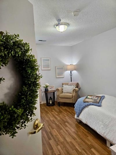 Cozy interior view of a resident room with a chair and decor