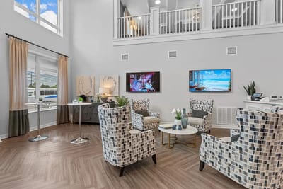 Common area with seating and televisions for residents