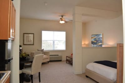 A bright and cozy resident room with seating area