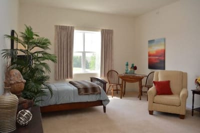 Bright, welcoming resident room with furnishings