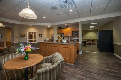 Bright common area with seating and kitchenette