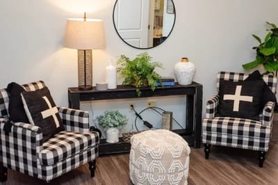 Cozy interior seating area with a lamp and decorative plants