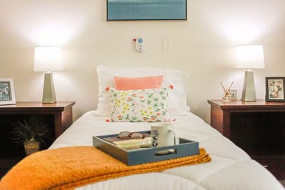 Cozy resident room decorated with lamps and pillows