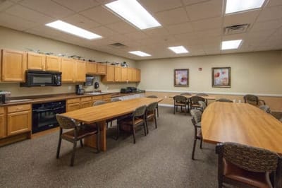 Interior dining/common area with wooden tables and chairs