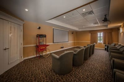 Bright common area with seating and a projector screen