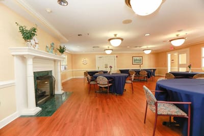 Common area with tables and chairs in a bright setting