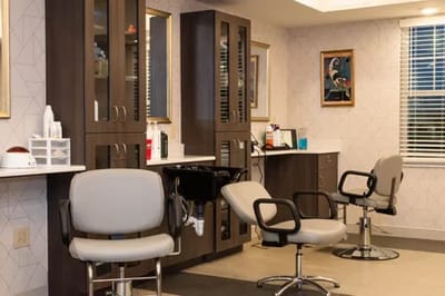Bright salon area with styling chairs and mirrors