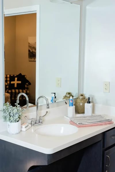 Clean bathroom sink area with toiletries
