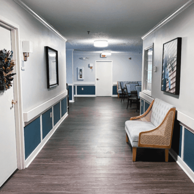 A quiet hallway with a bench and artwork