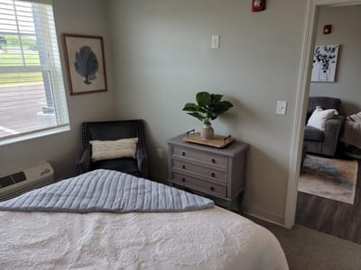 Cozy resident room with a bed and chair