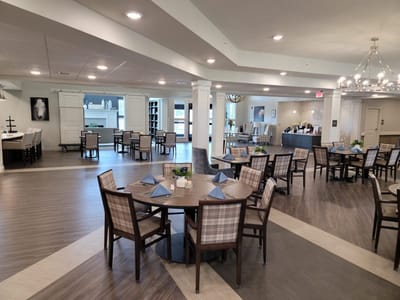 Bright dining area with tables set for residents