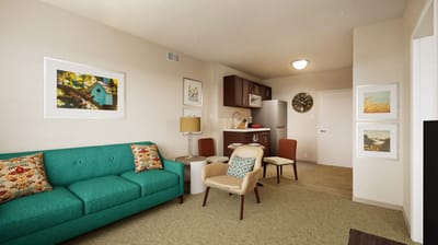 Bright interior living space with a sofa and kitchen area
