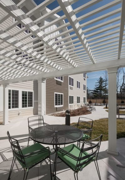 Outdoor patio area with seating and a pergola