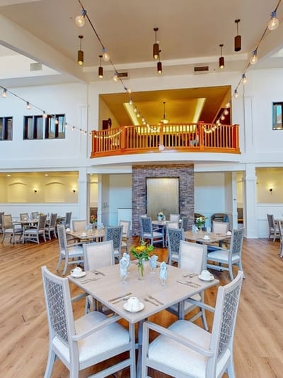 Bright dining room with tables and chairs set for meals