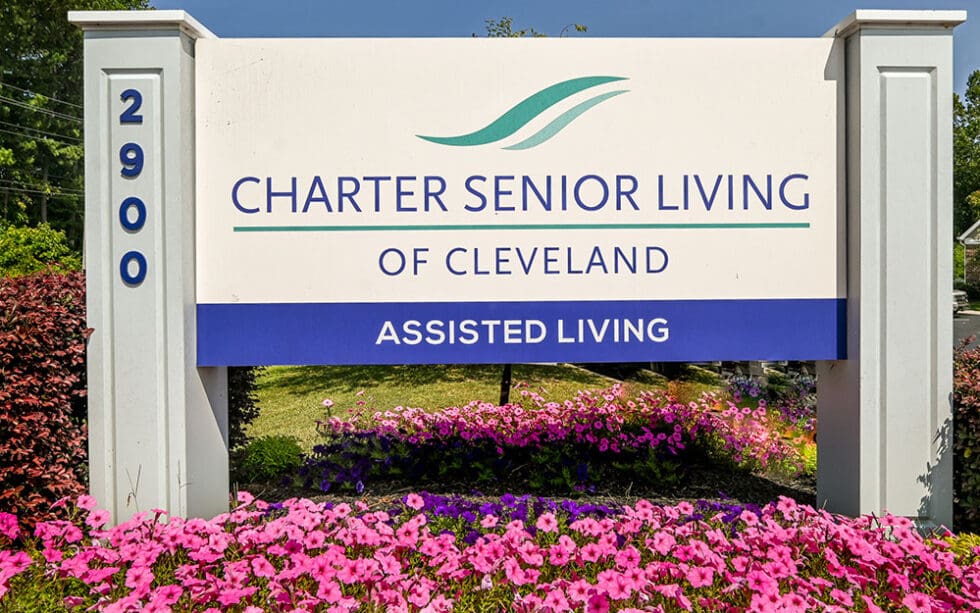 Sign for Charter Senior Living of Cleveland surrounded by flowers